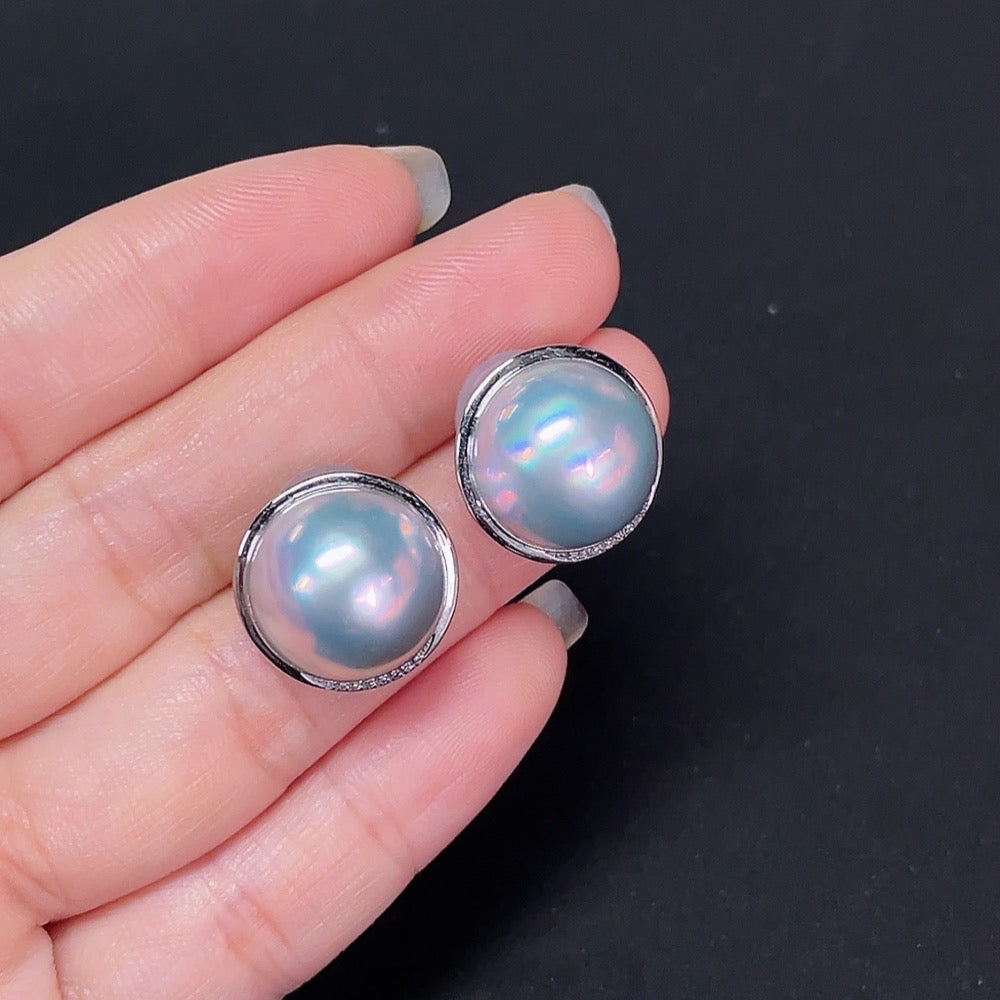 HKHQ composite saltwater pearl stud earrings with platinum settings and diamond accents, showcasing elegant jewelry craftsmanship.