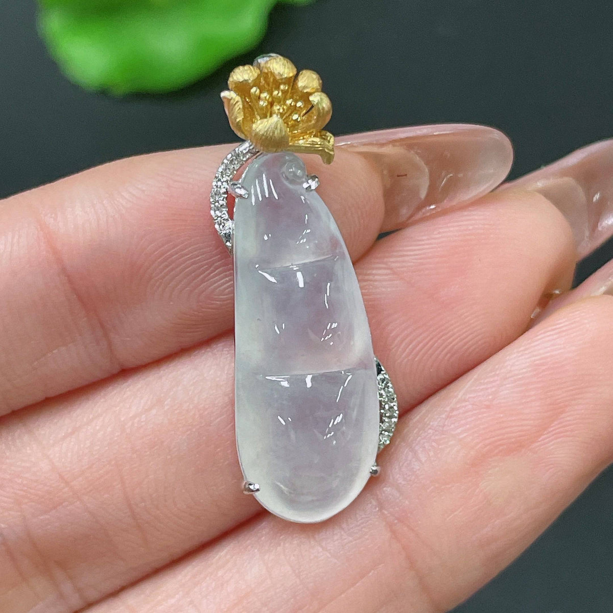 Huiliu Jadeite pendant with bean shape inlaid with diamonds, featuring a polished jade surface and intricate craftsmanship.
