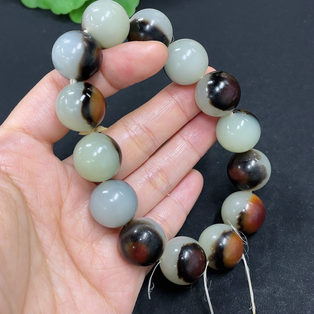 HKHQ Hetian Jade bracelet with 15.5mm beads, approximately 83g, showcasing smooth jade stones on a neutral background.