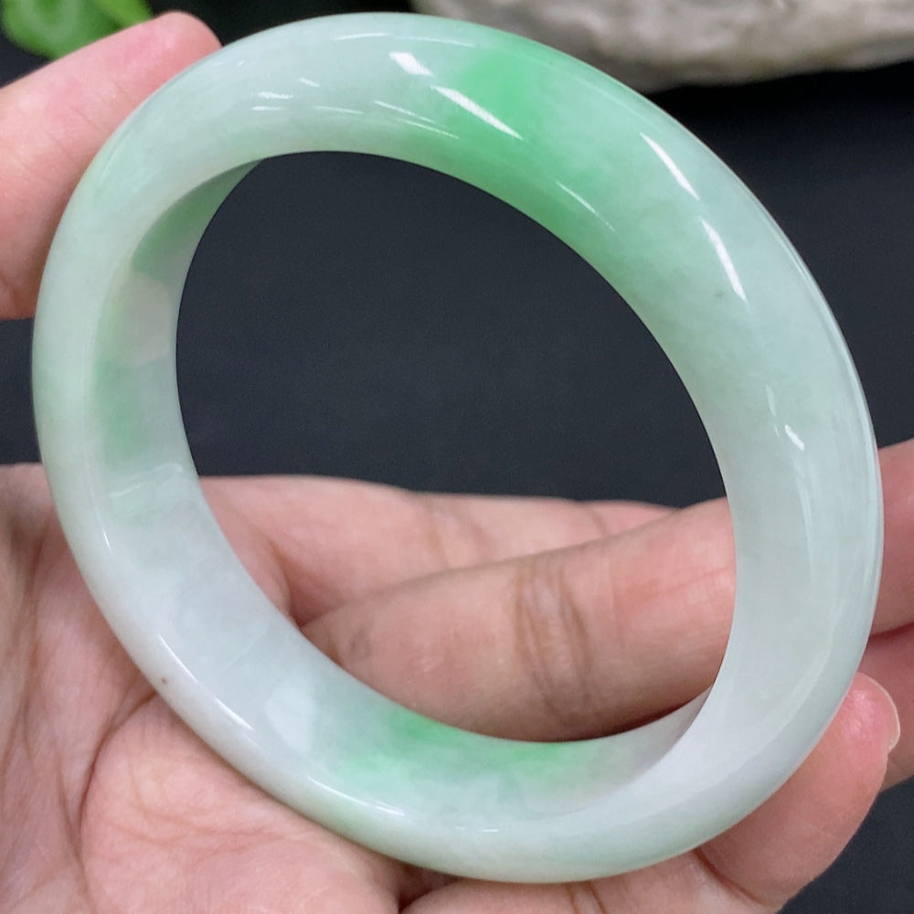 HKHQ jadeite round bangle in size 53.8 with a smooth, polished surface and a weight of 56.6 grams, showcasing vibrant green jadeite.