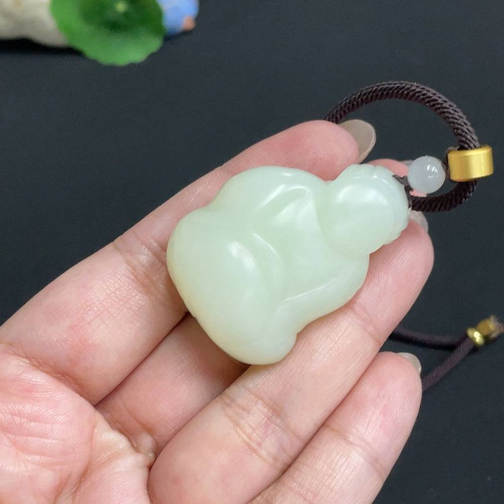 Hetian jade pendant featuring the God of Wealth, weighs approx. 34.8g, with a detailed jade carving on a rope necklace.