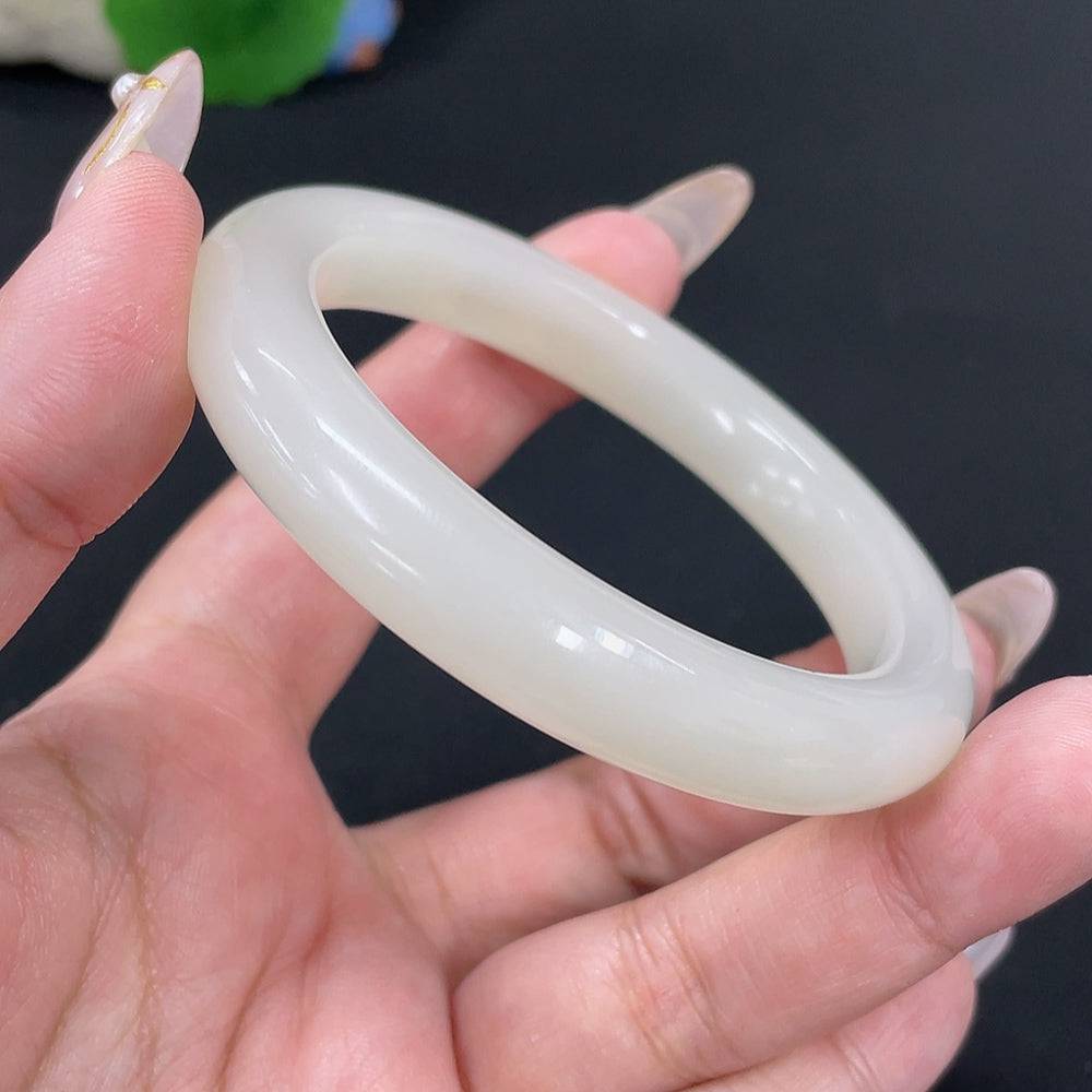 Huiliu Certified Hetian Jade round bracelet featuring smooth, polished jade beads on a delicate string, showcasing natural green hues.