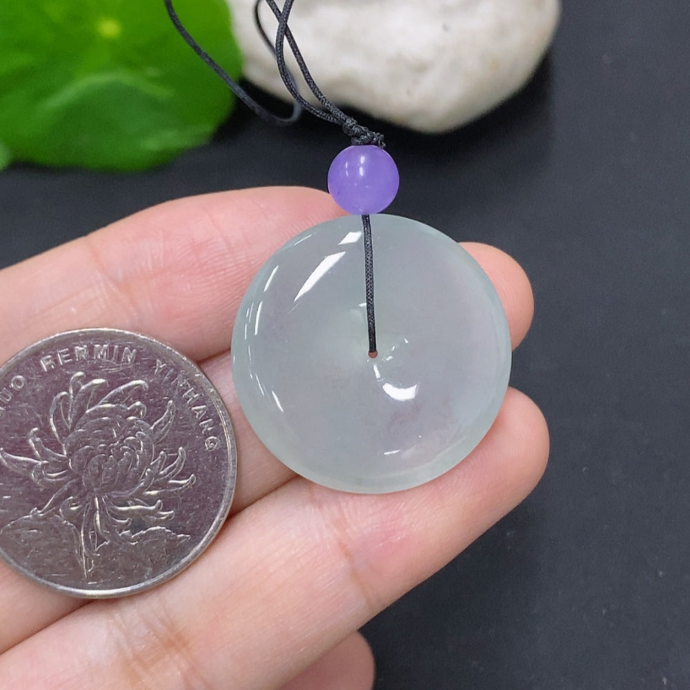 Jadeite Peace Knot pendant by HKHQ, approximately 7.6 grams, featuring a detailed carved design in green jade with beads.