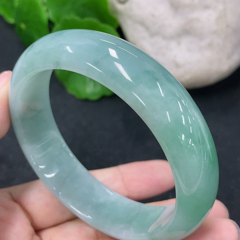 HKHQ jadeite round bangle in size 54.7, weighing 57.3g, showcasing smooth, polished jadeite with a circular shape and elegant finish.