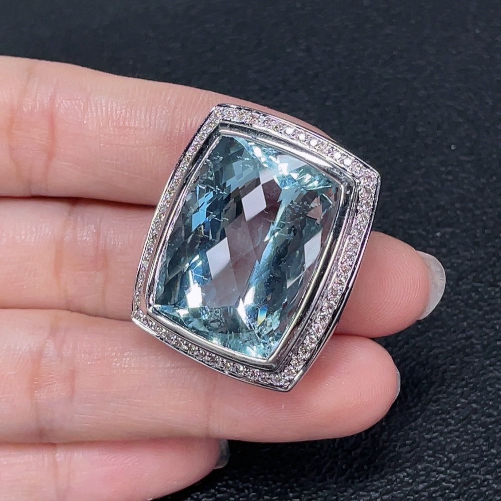 Aquamarine pendant with diamond accents, 18K gold setting, featuring a sparkling gemstone and elegant design.