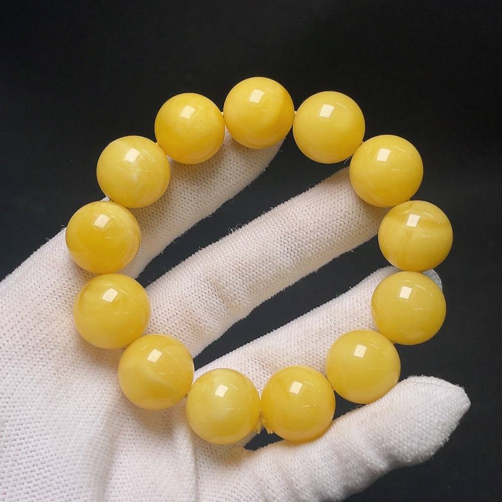 Huiliu amber beeswax bead bracelet with round amber beads, approximately 16.1mm size, featuring natural amber color and smooth finish.