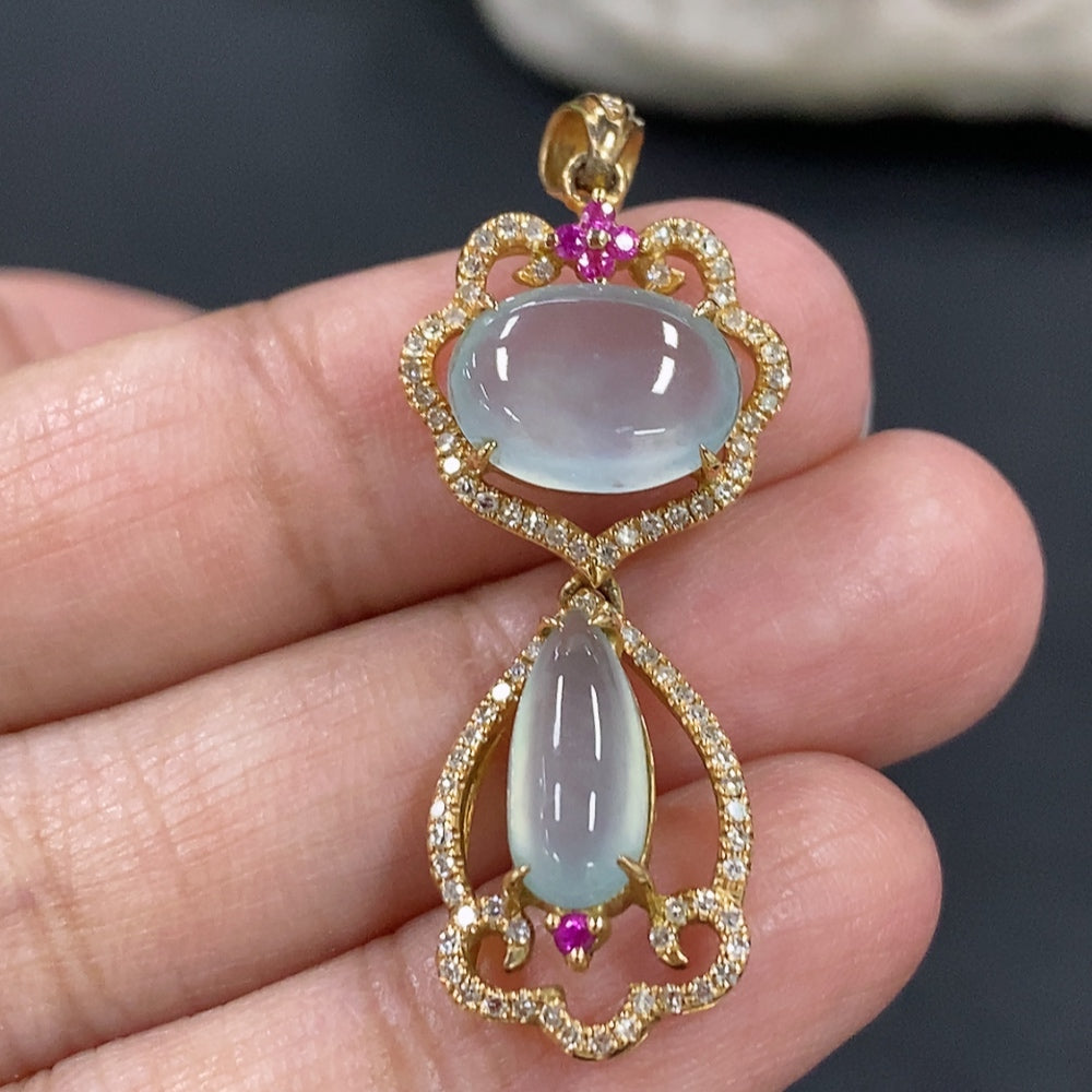 Jadeite cabochon pendant with 18K gold setting and diamond accents, showcasing a smooth green jade stone on a delicate chain