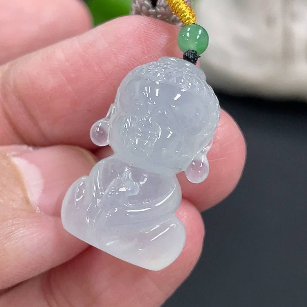 Jadeite Baby Buddha pendant from HUILIU HQ featuring a smooth, polished jade carving of a baby Buddha on a string.