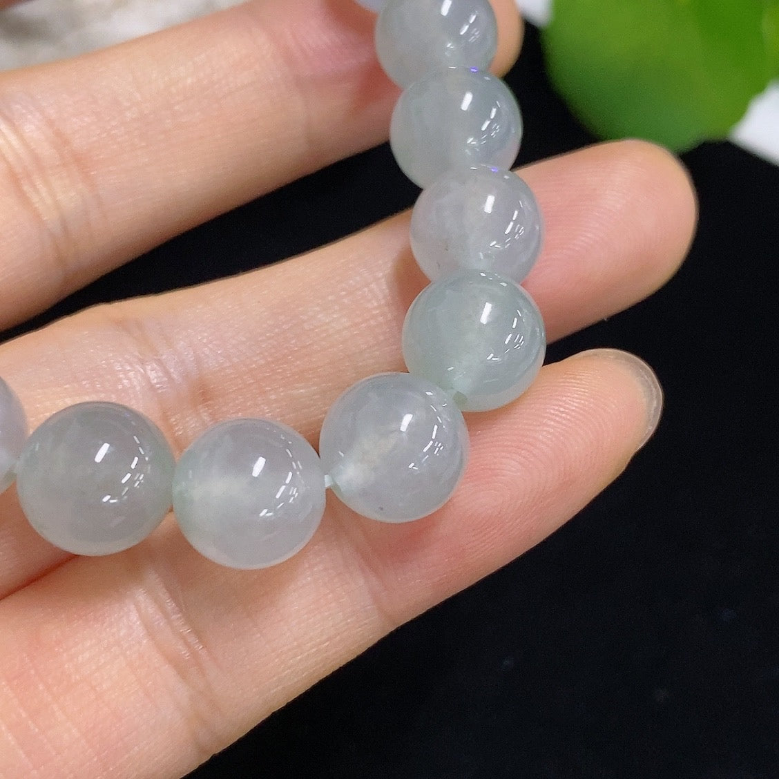 HKHQ jadeite bracelet weighing 28.68g, showcasing smooth, polished jadeite beads on a delicate bracelet.