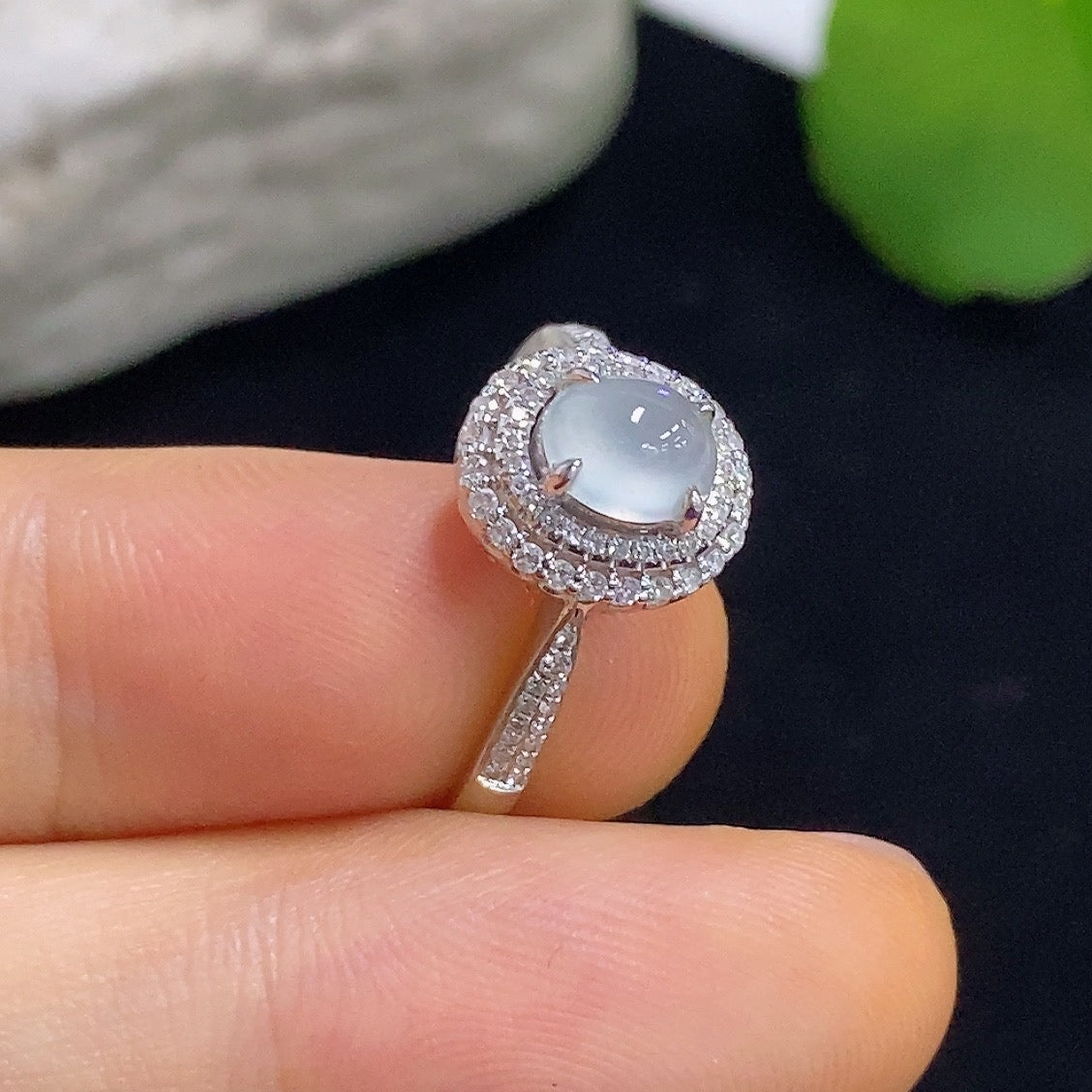 Jadeite cabochon solitaire ring with 18K gold band and diamond accents, showcasing elegant gemstone and fine craftsmanship.