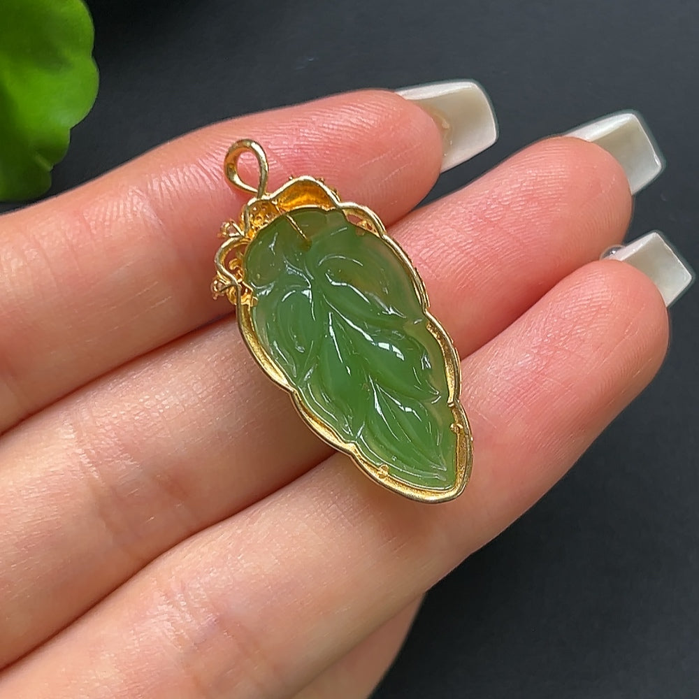 Green Hetian jade leaf pendant on 18K gold necklace, featuring a non-diamond design, crafted by HKHQ.