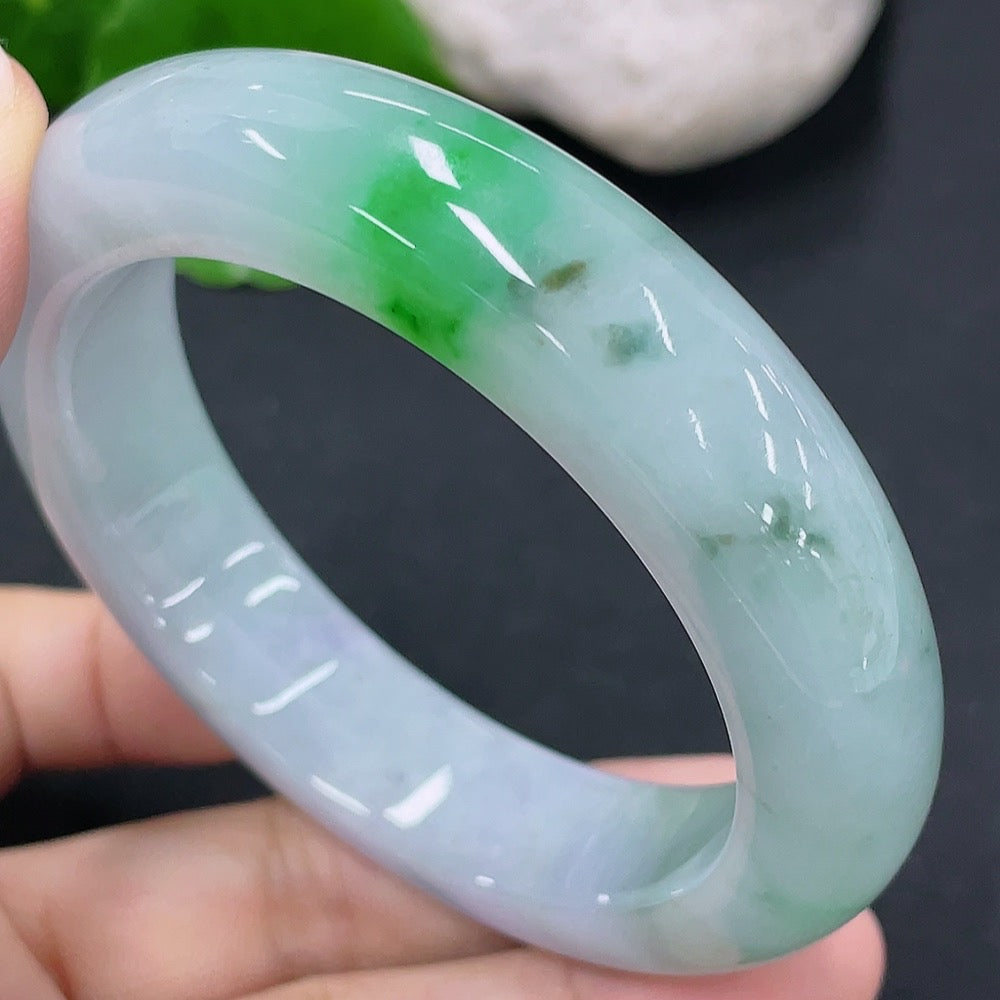 Elegant jadeite round bangle by HKHQ, featuring a smooth, polished jade bracelet with a natural green hue and rounded design.