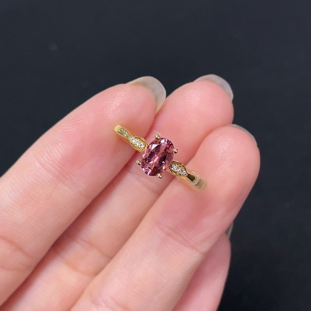 18K gold tourmaline ring by HKHQ featuring a vibrant green gemstone set in a sleek gold band.