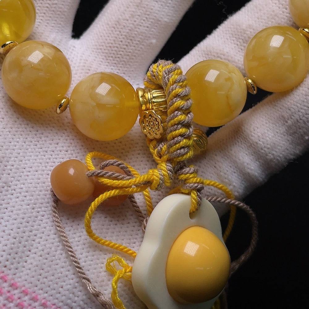 Amber beeswax bracelet with visible repairs, cord, non-metal, accented with non-natural stones, size 16.5mm, HUILIU HQ certified.
