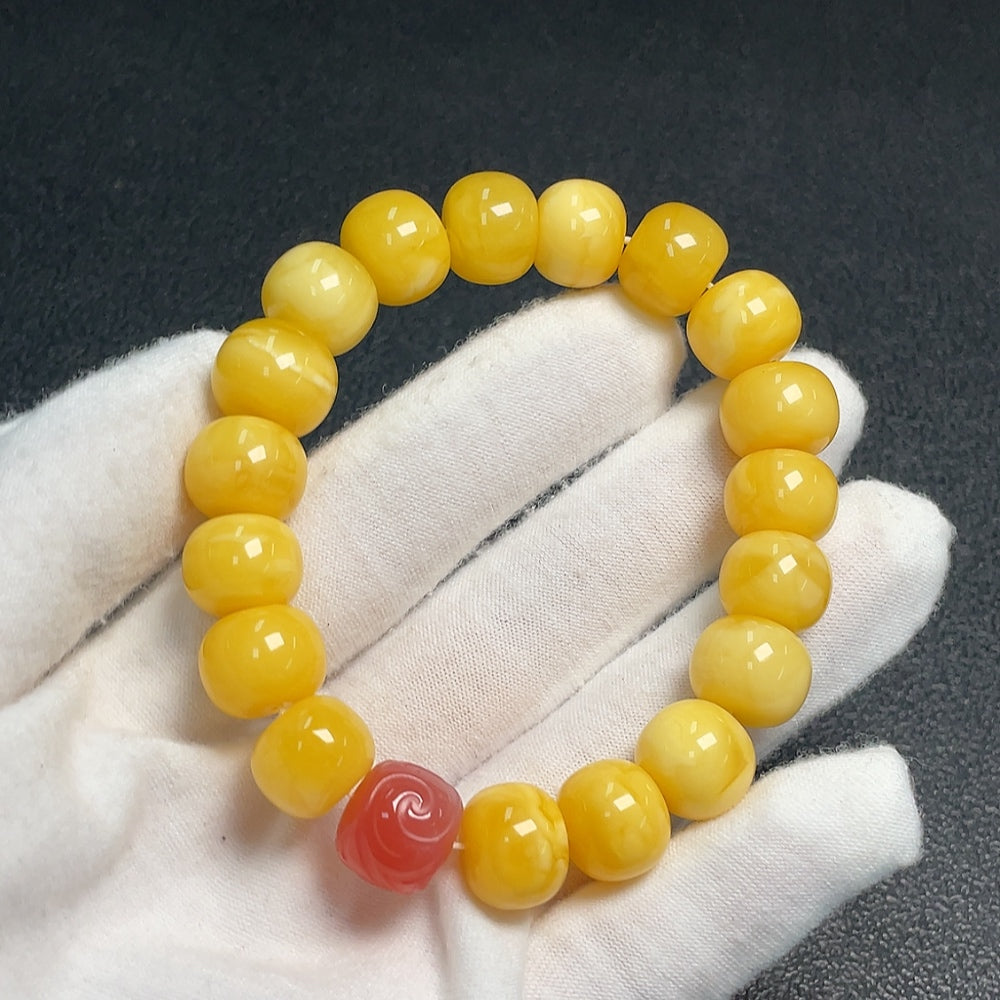 Amber beeswax bracelet with Southern Red Agate beads from HUILIU HQ, showing the natural amber and red stone details.