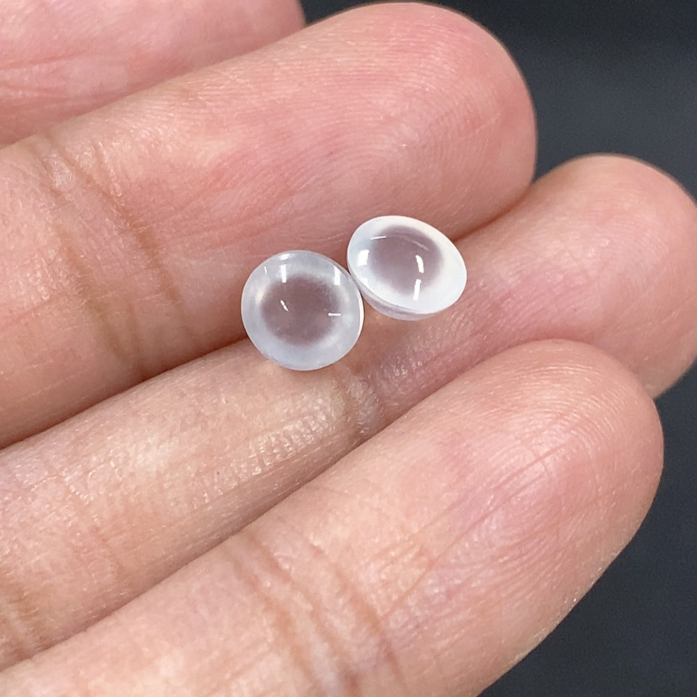 Close-up of a 0.49g jadeite cabochon jewelry piece, showcasing smooth, polished green gemstone with subtle natural patterns.