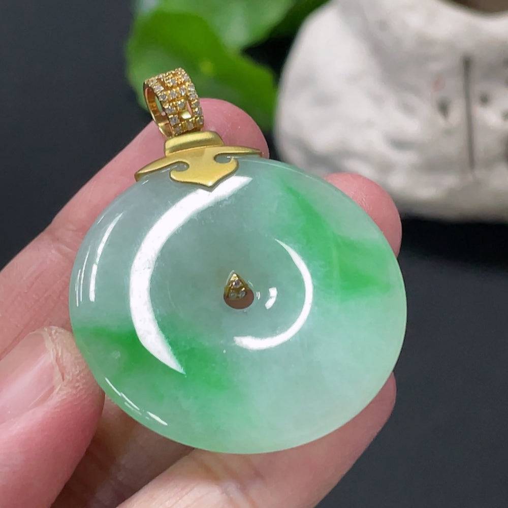 Jadeite Peace Knot pendant with 18K gold clasp, diamond accents, showcasing intricate jade design and elegant craftsmanship.
