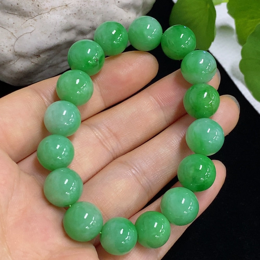 Jadeite bracelet with 11mm beads weighing approximately 43g, featuring smooth, polished jade stones from HKHQ.
