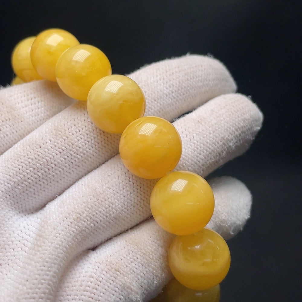 Amber beeswax bracelet by HUILIU HQ featuring natural amber beads, approximately 14.1mm in size and 23.8g in weight.