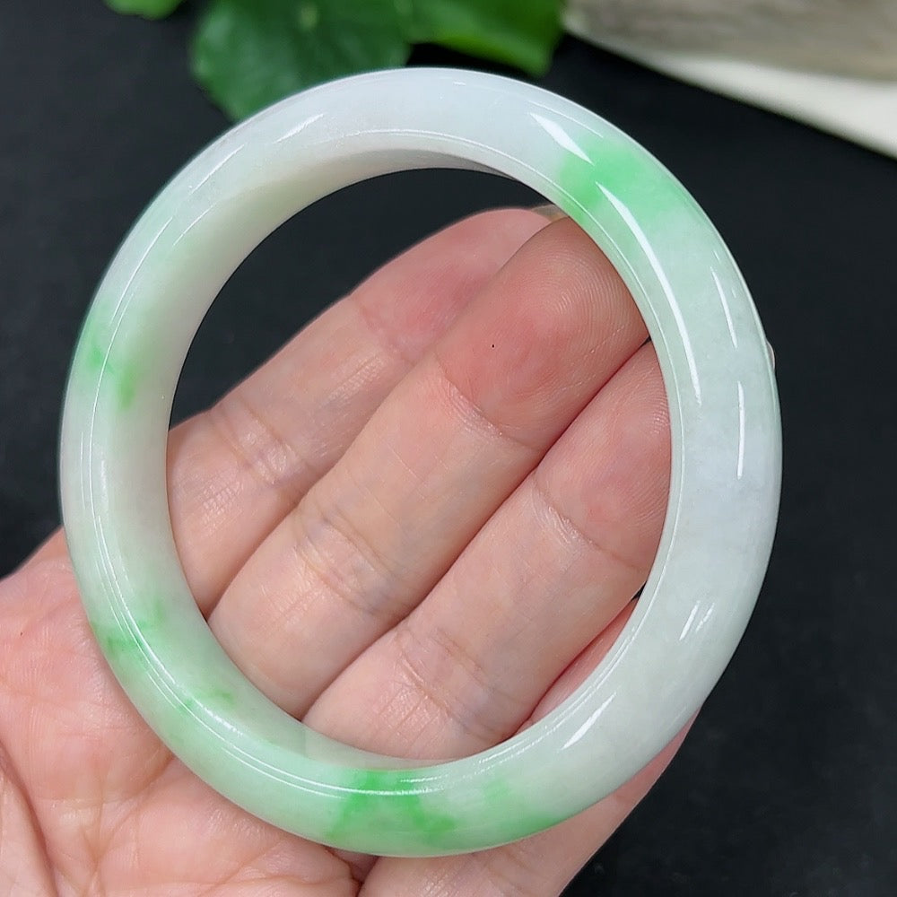 HKHQ jadeite round bangle in size 56, showcasing smooth polished surface and vibrant green color, weighs 51.3 grams.