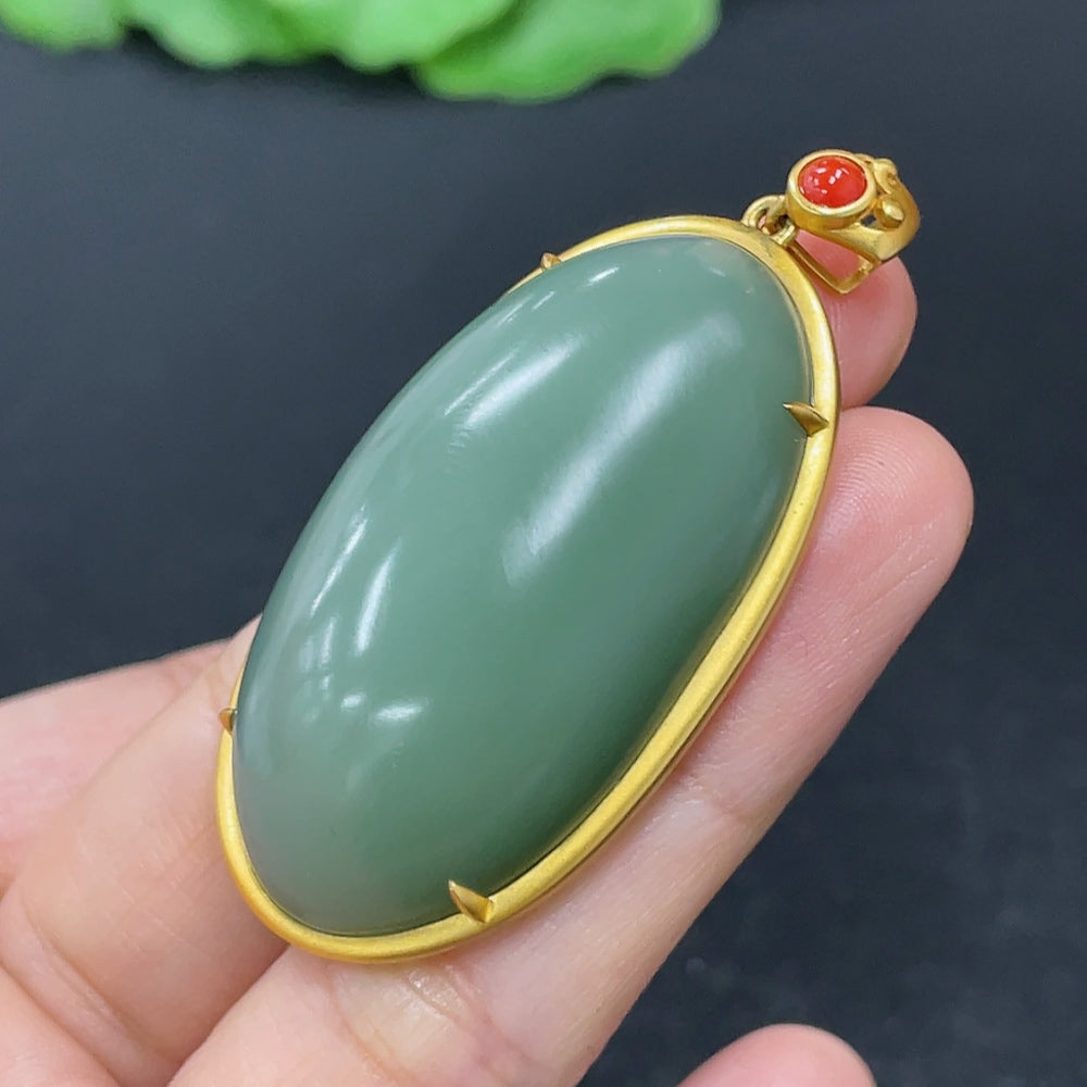 Hetian Jade cabochon pendant on 18K gold necklace with beads, crafted by HKHQ, displayed against a neutral background.