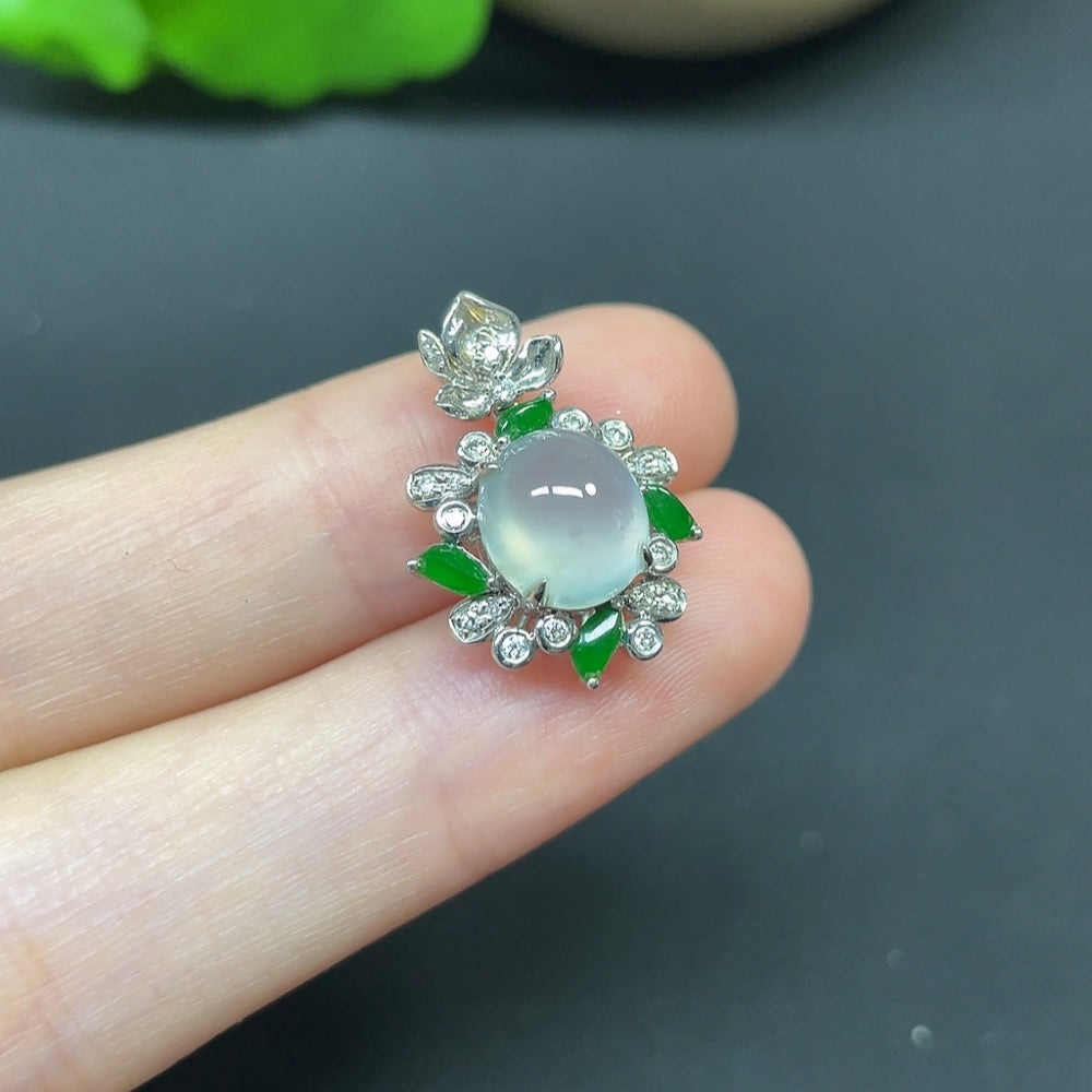 Jadeite cabochon pendant in 18K gold with diamond accents, showcasing a polished green gemstone on a delicate necklace.