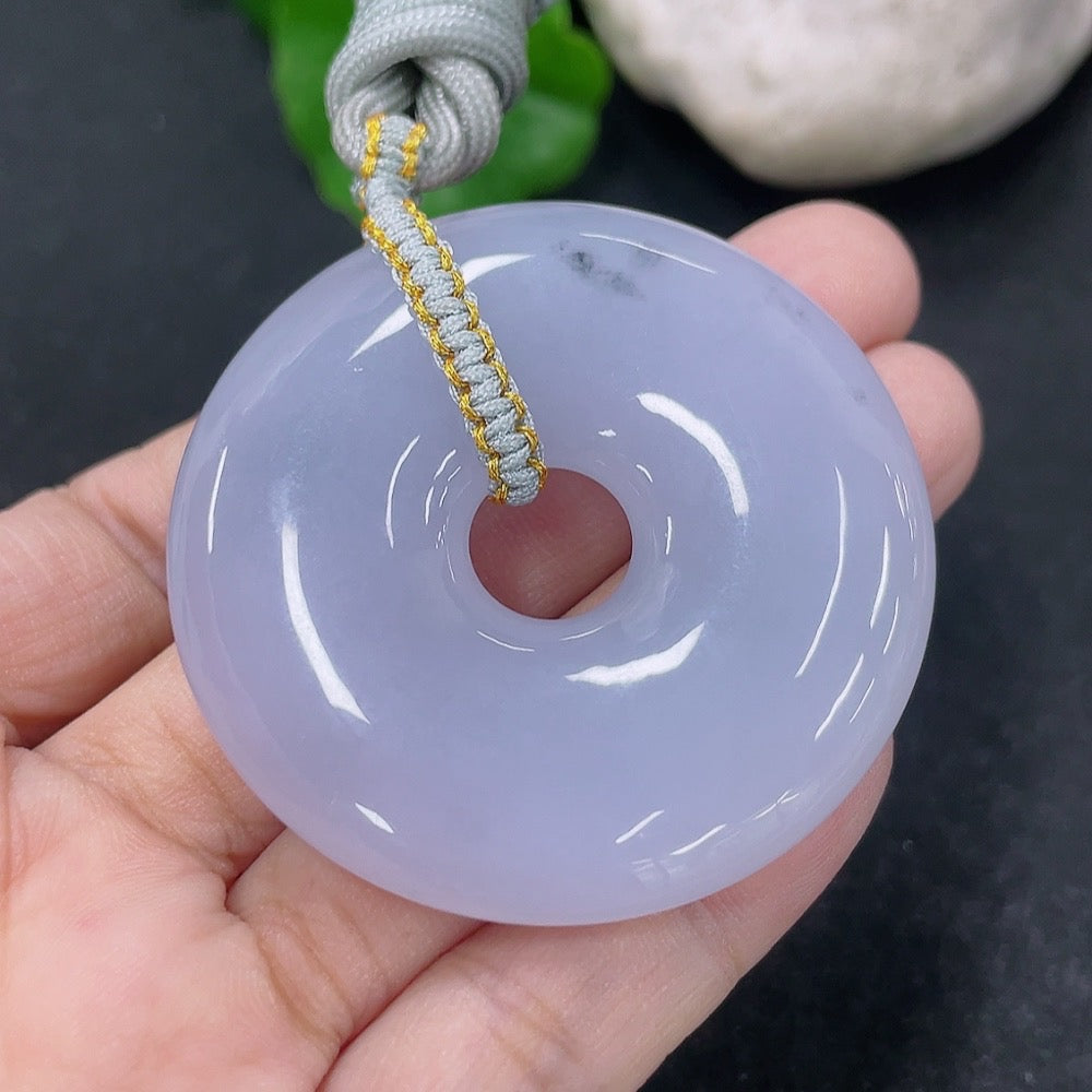 Jadeite pendant donut with a rope, weighing approximately 42.54g, featuring smooth, polished green jade stone and natural stone texture.