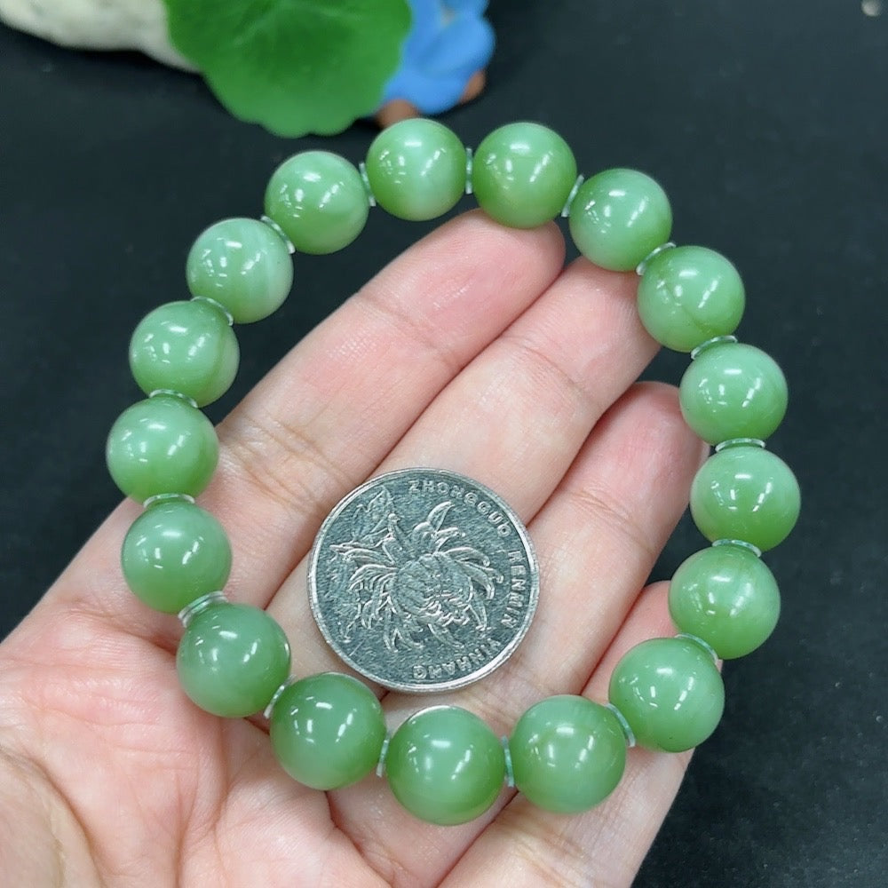 Green Hetian Jade bracelet from HKHQ featuring smooth, polished jade beads on a delicate string.