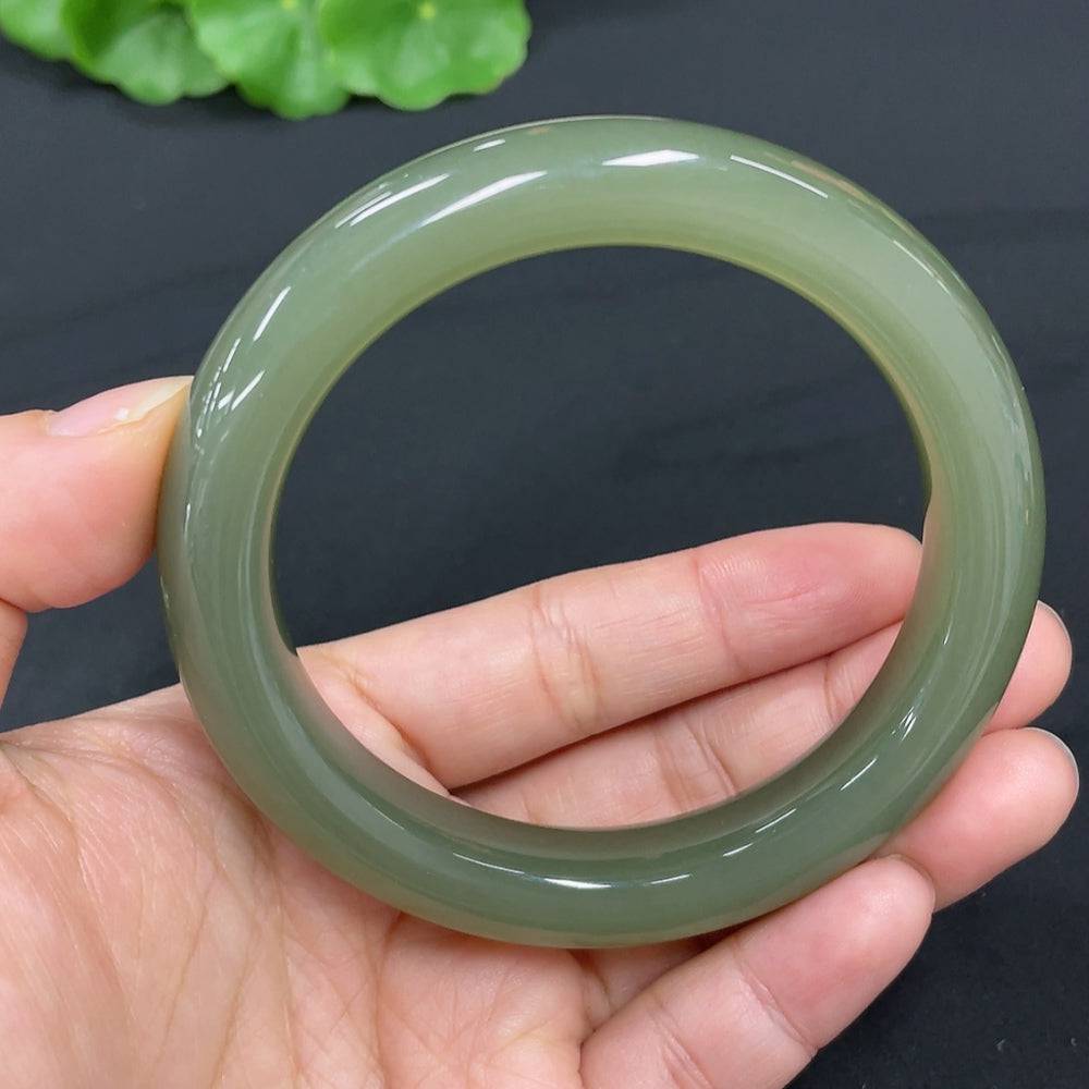 Huiliu certified Hetian jade round bracelet with smooth, polished jade beads showcasing natural green hues and craftsmanship.