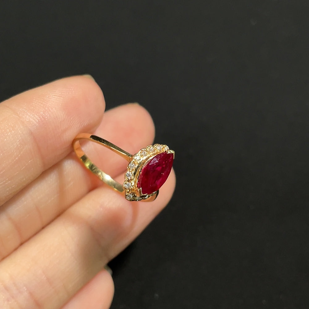 HKHQ ruby ring with diamond accents, 18K gold, showcasing a vibrant red gemstone and sparkling diamond details.