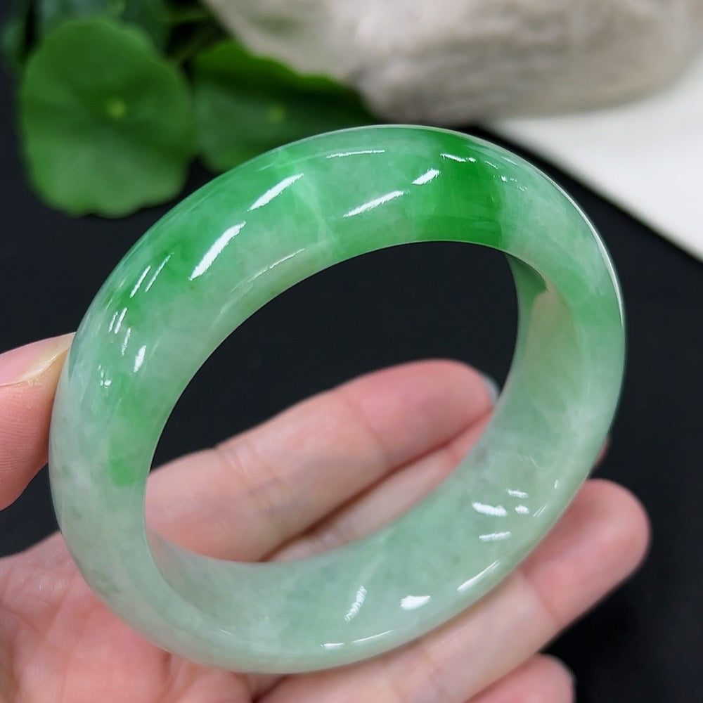 HKHQ jadeite round bangle in size 53.6 with an approximate weight of 82g, showcasing smooth, polished jade surface.