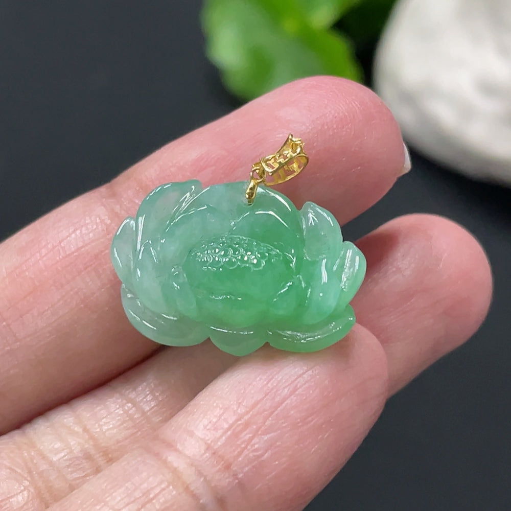 Jadeite lotus pendant with 18k gold clasp, weighs approximately 3.38g, featuring intricate carved lotus design.