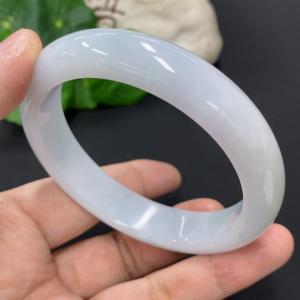 Huiliu Certified Jadeite round bangle showcasing smooth, polished green jade with natural variations and a glossy finish.