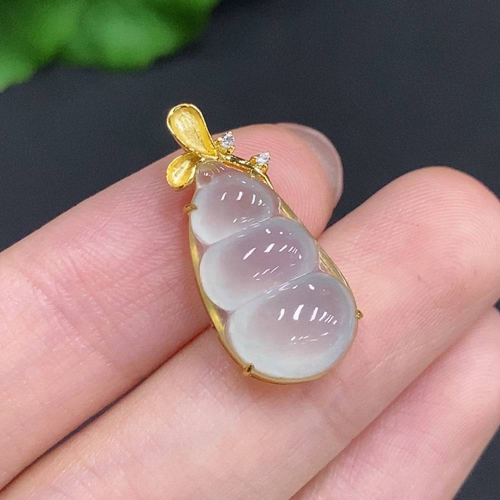 Jadeite lucky bean pendant with diamond accents, 18k gold, weighing about 2.4g, by HUILIU HQ, displayed against a neutral background.