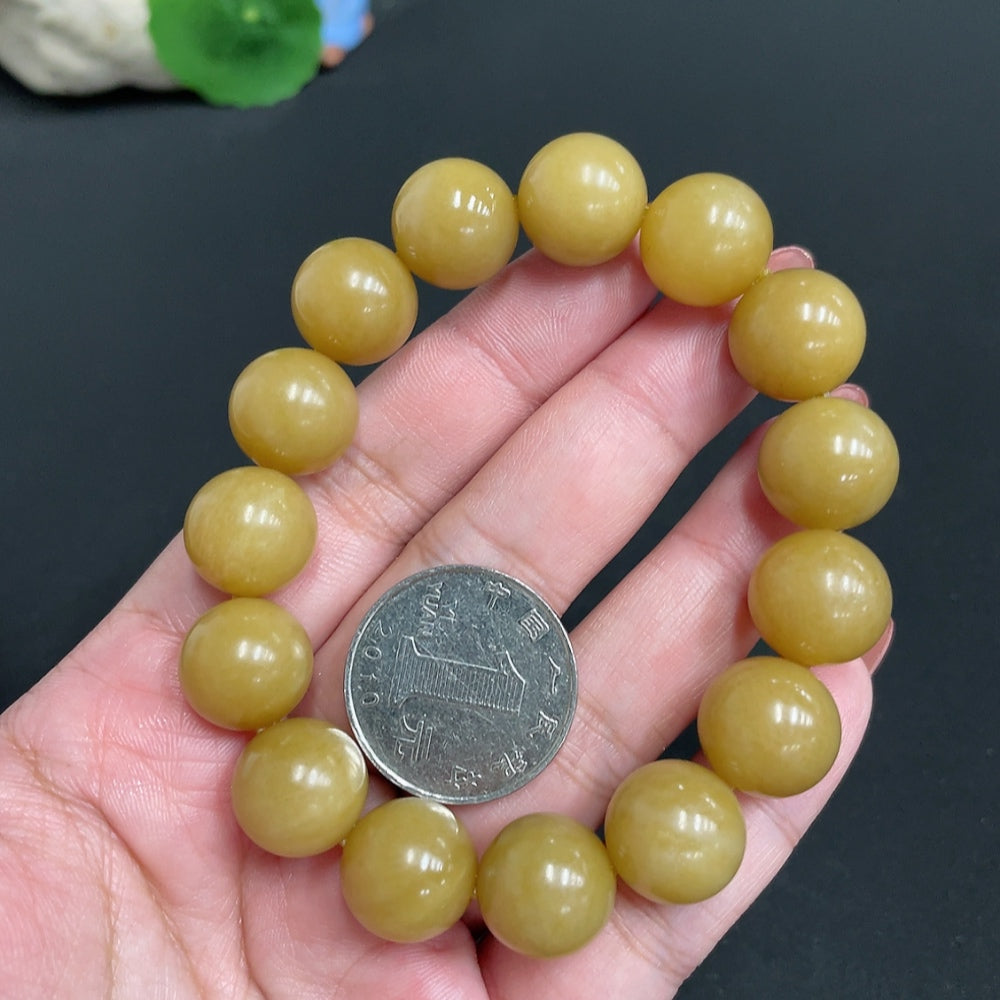 Hetian jade bracelet with 13.6mm beads, weighing approximately 61.7g, featuring smooth, polished jade stones.