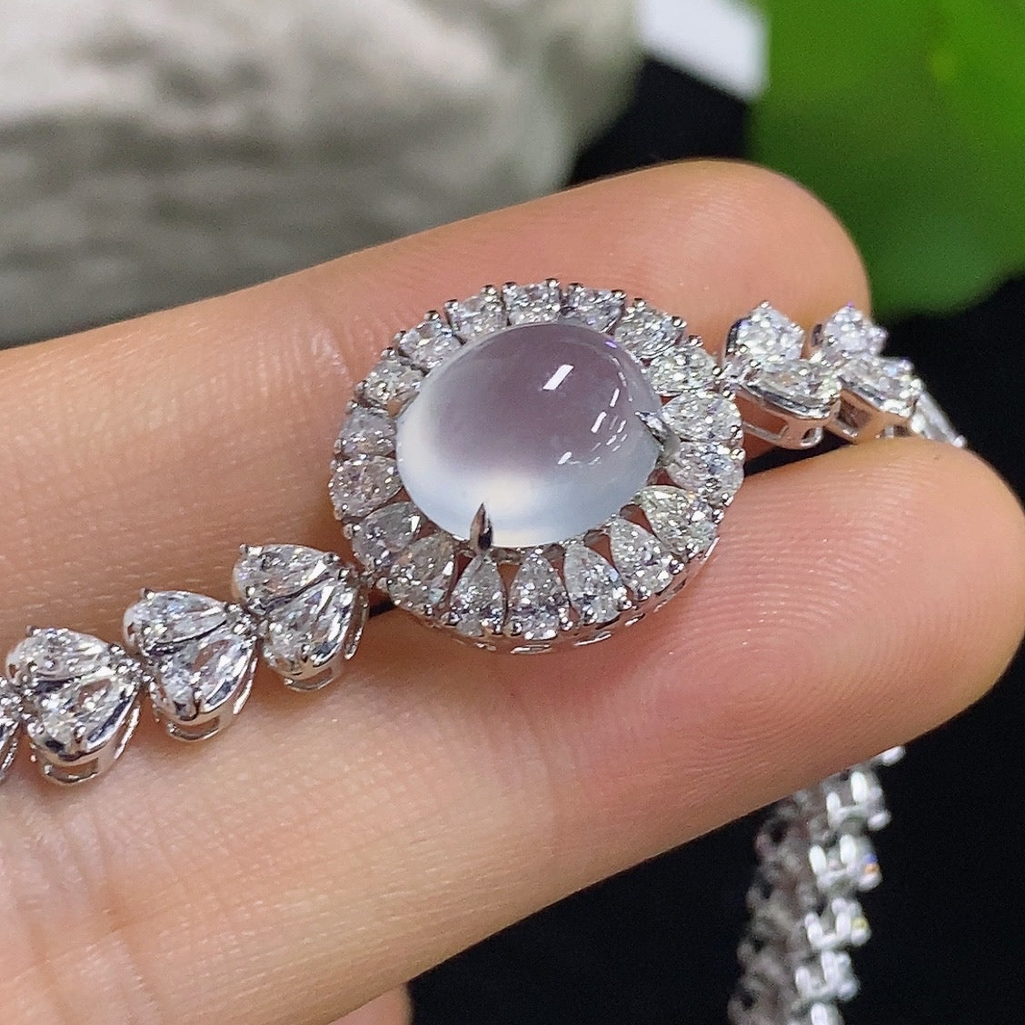 Elegant jadeite cabochon bracelet by HKHQ featuring 18K gold and diamond accents, showcasing a luxurious jewelry piece.
