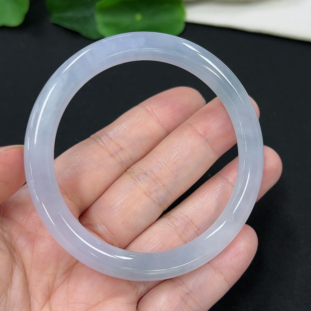 Jadeite round bangle in size 54.7, weighing approximately 27.7g, featuring smooth, polished green jade material from HKHQ.
