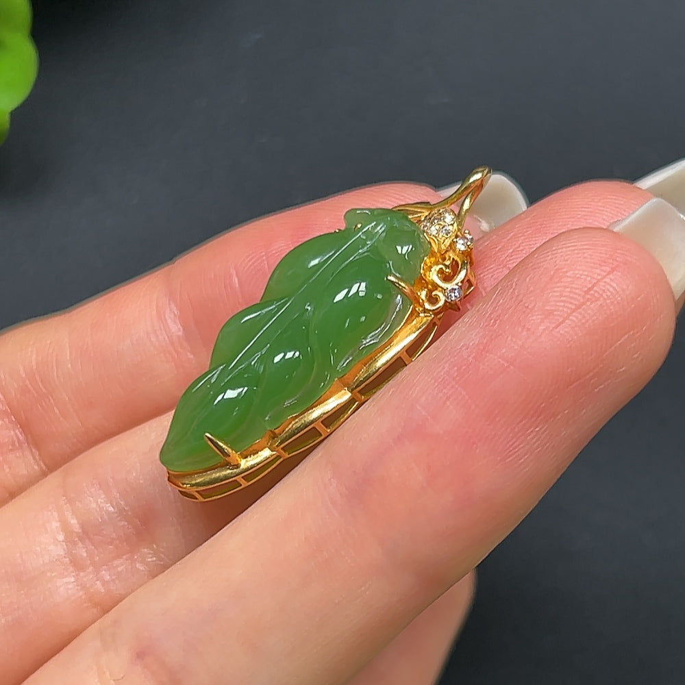 Green Hetian Jade leaf pendant necklace with 18K gold setting, featuring a non-diamond design and intricate detailing.