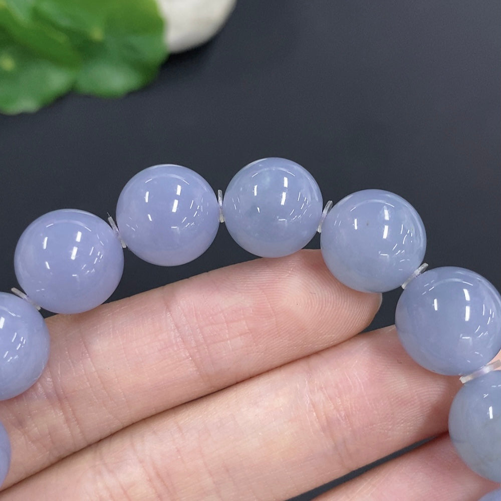 HKHQ jadeite bracelet with approximately 12.7mm beads, weighing around 56.7g, showcasing smooth, polished green jade stones.