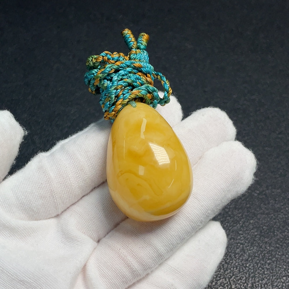 Huiliu Amber Beeswax Pendant on rope, natural amber jewelry with a polished beeswax finish, certified by HUILIU HQ