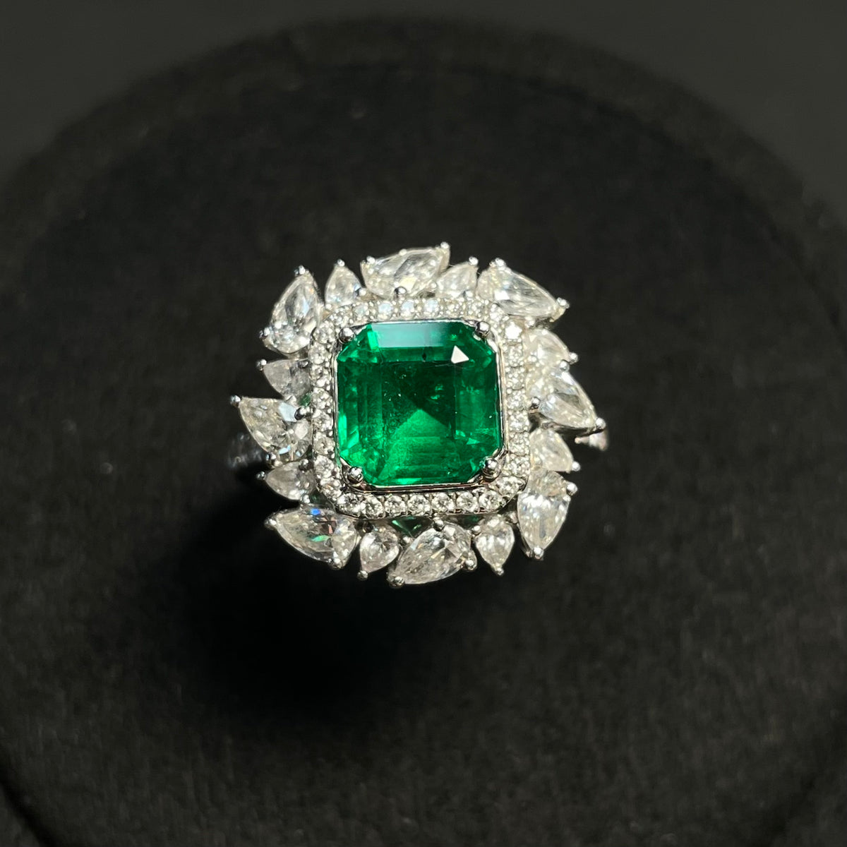 Emerald ring with clarity enhancement, set in 18K gold with diamond accents, showcasing a luxurious jewelry piece.