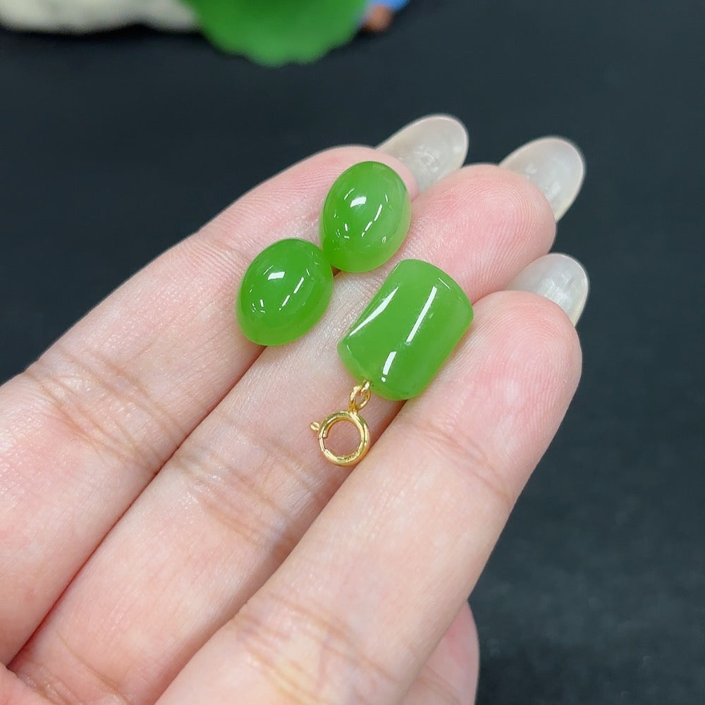 HKHQ Hetian Jade inlaid earrings with 18K gold, featuring intricate design and green jade accents, displayed on a neutral background.