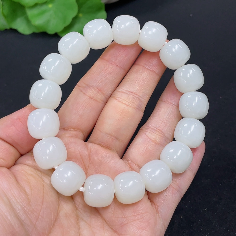 HKHQ Hetian Jade bracelet with smooth green stones, weighing 60.5g, displayed on a neutral background.