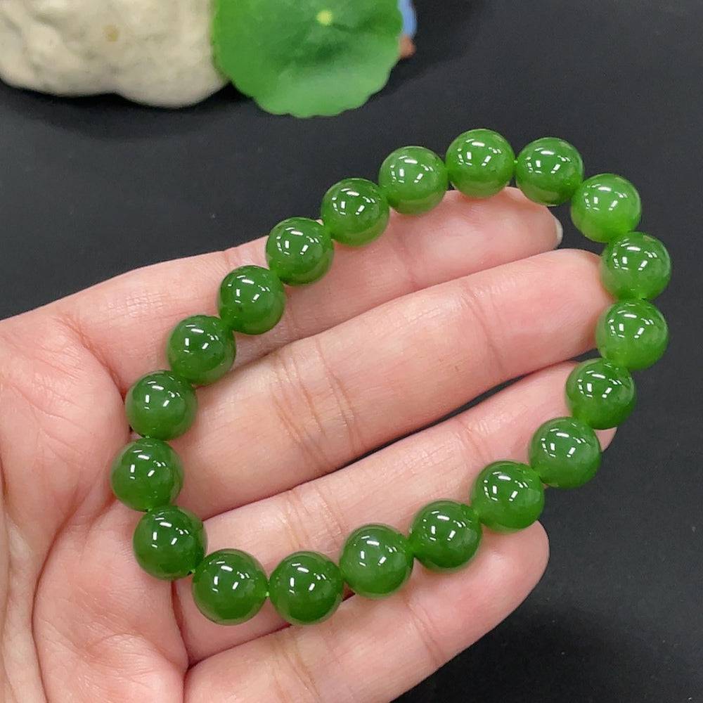 Hetian jade bracelet by HUILIU HQ featuring 9.5mm smooth jade beads, weighing approximately 28.6 grams.