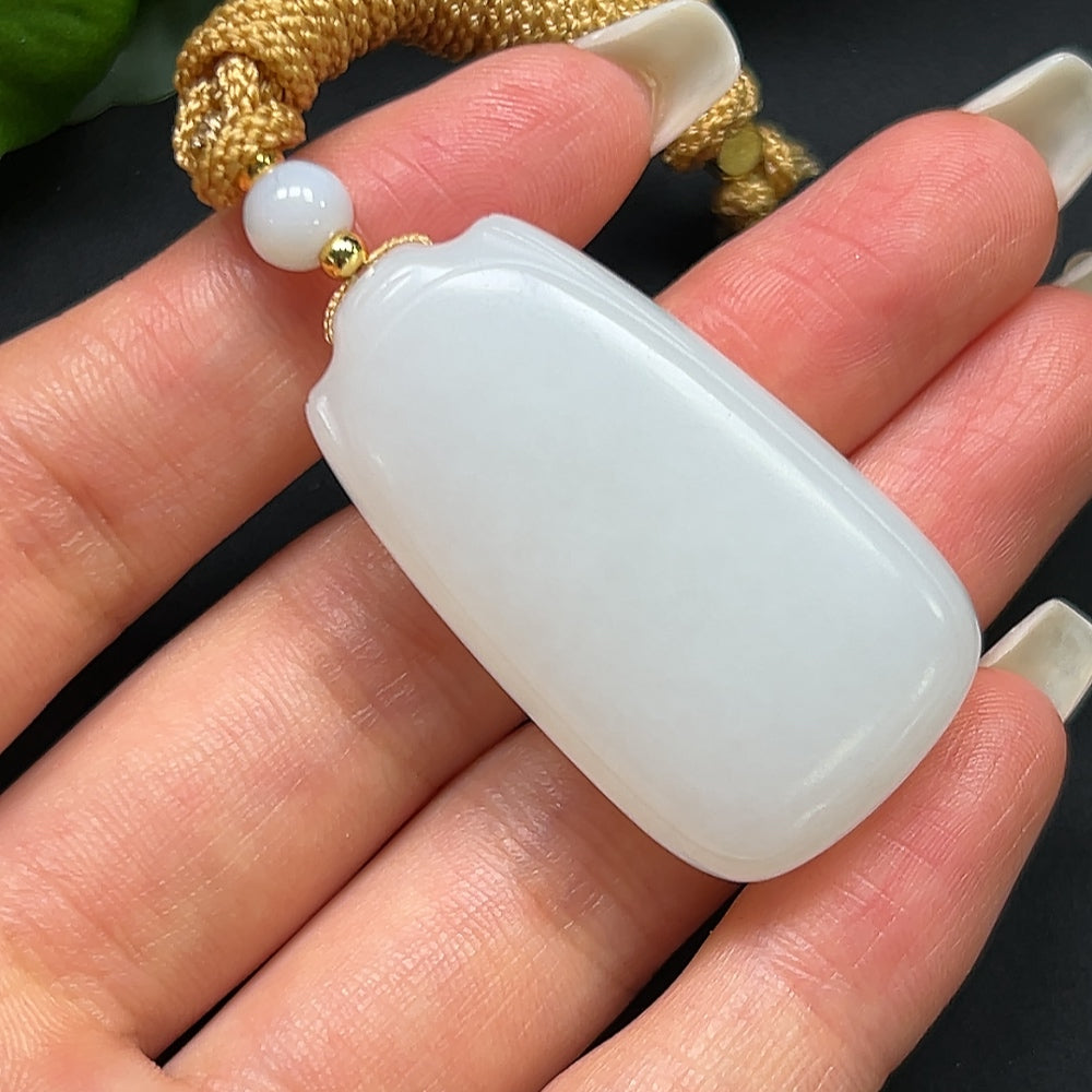 HKHQ Hetian Jade plain pendant with rope, weighing approximately 27.31g, showcasing smooth, polished jade craftsmanship.