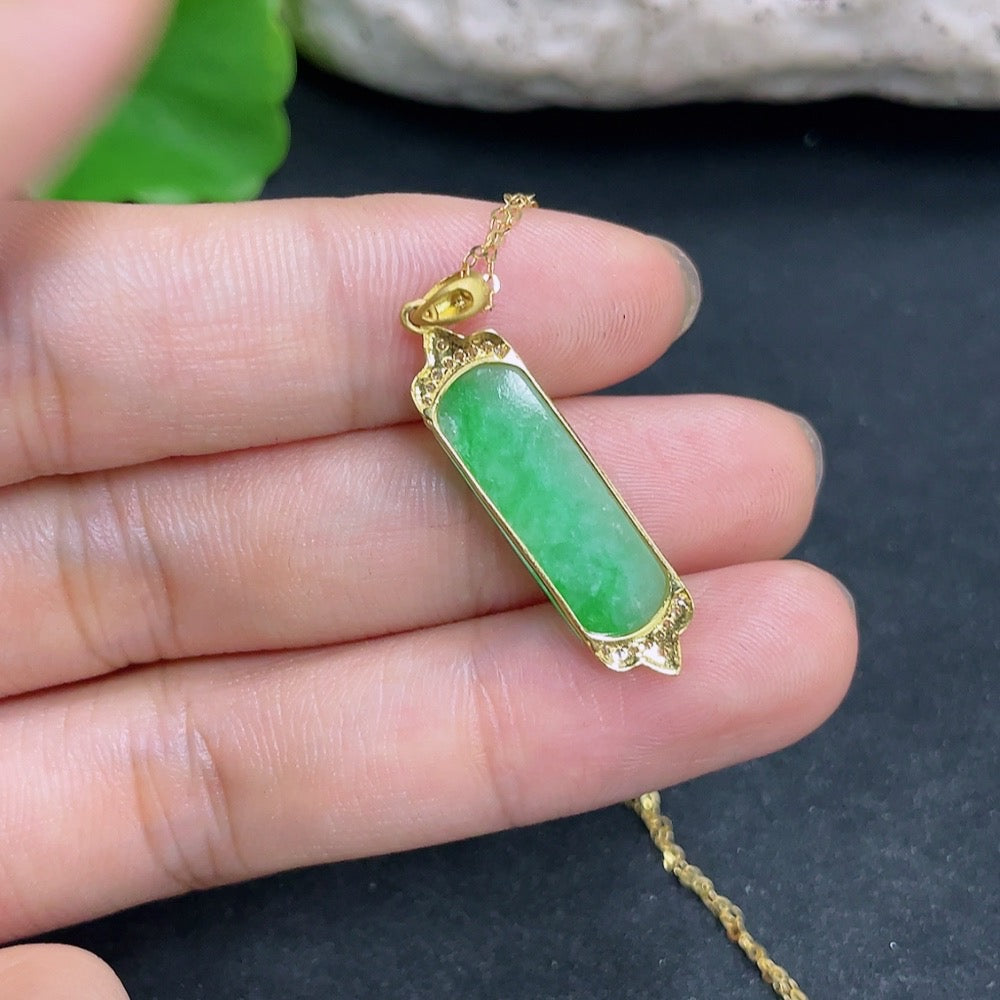 Jadeite pendant with 18K gold and diamond accents, showcasing a polished green jade stone in a delicate necklace design.