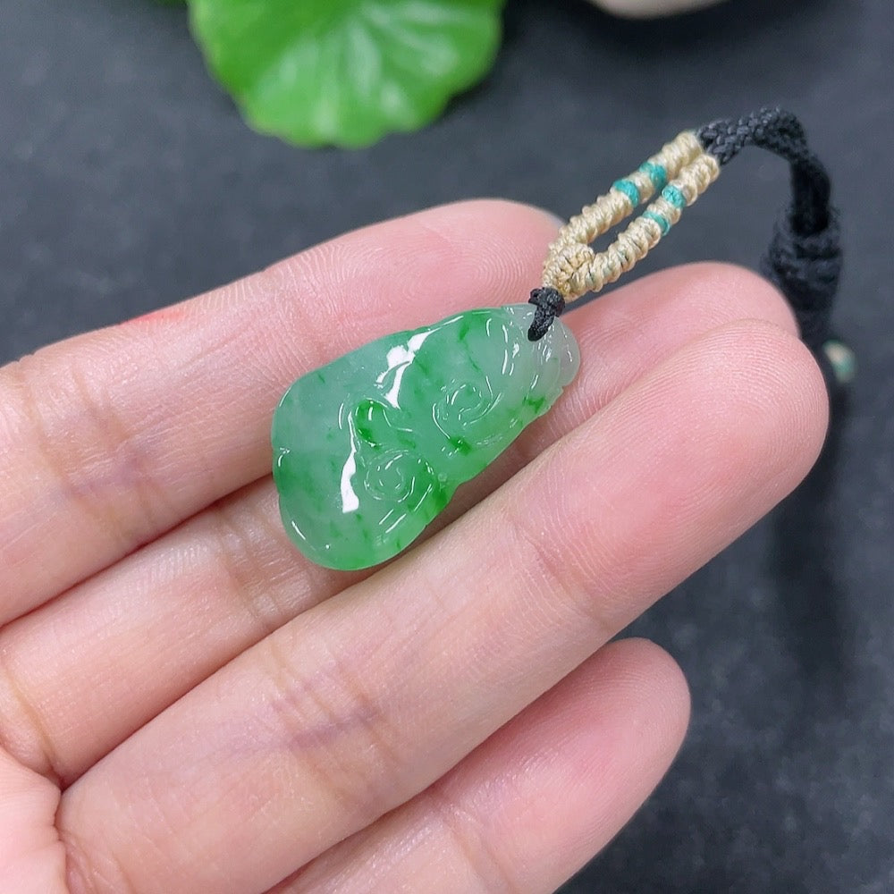Jadeite pendant with Ruyi design, weighing approximately 4.45g, featuring a matching rope, from HKHQ.