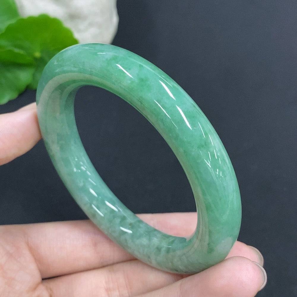 Huiliu certified jadeite round bangle showcasing smooth, polished green jade with a glossy finish.