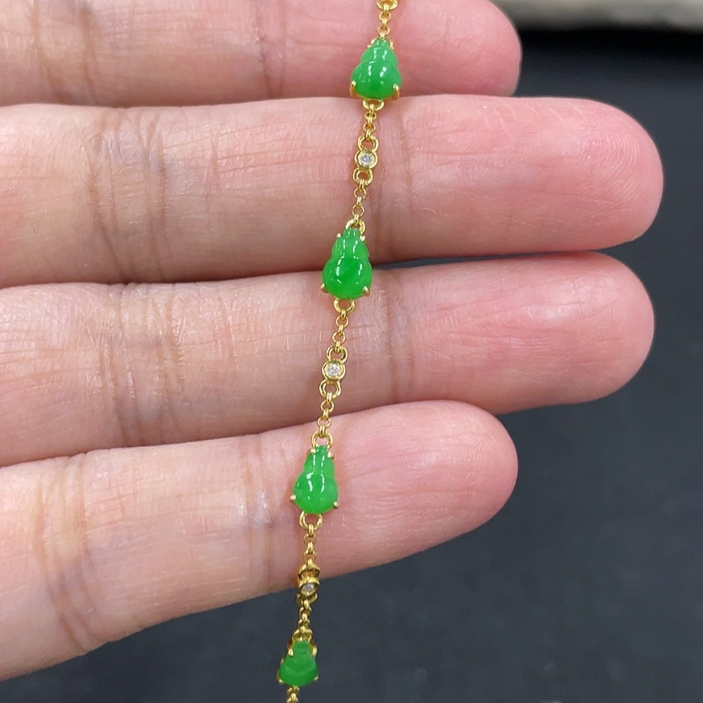 Jadeite gourd bracelet with 18k gold inlay from HKHQ, showcasing smooth jade stones and intricate gold details.