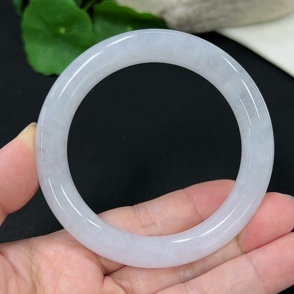 Jadeite round bangle with size 55 and weight 53.33g, crafted from smooth green jade, displayed on a neutral background.